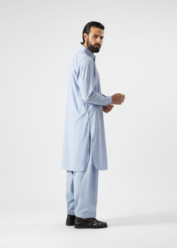 Man wearing a light blue traditional outfit